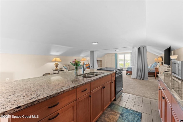 8865 Central Ave, Micco, FL 32976 - kitchen featuring a sink, appliances with stainless steel finishes, open floor plan, brown cabinetry, and lofted ceiling