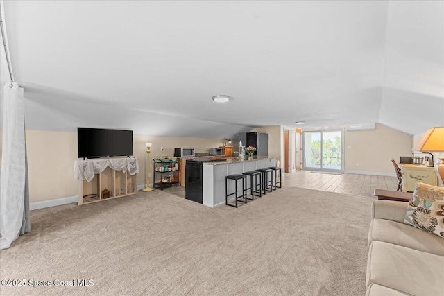 8865 Central Ave, Micco, FL 32976 - living room with lofted ceiling, light carpet, and baseboards
