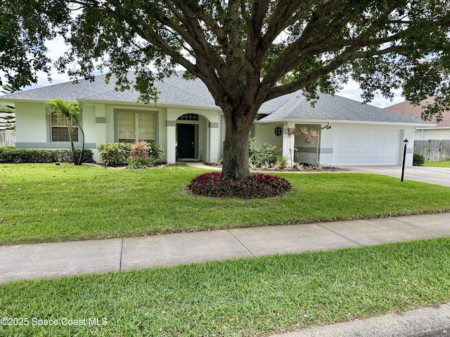 ranch-style house featuring a garage, stucco siding, concrete driveway, and a front lawn