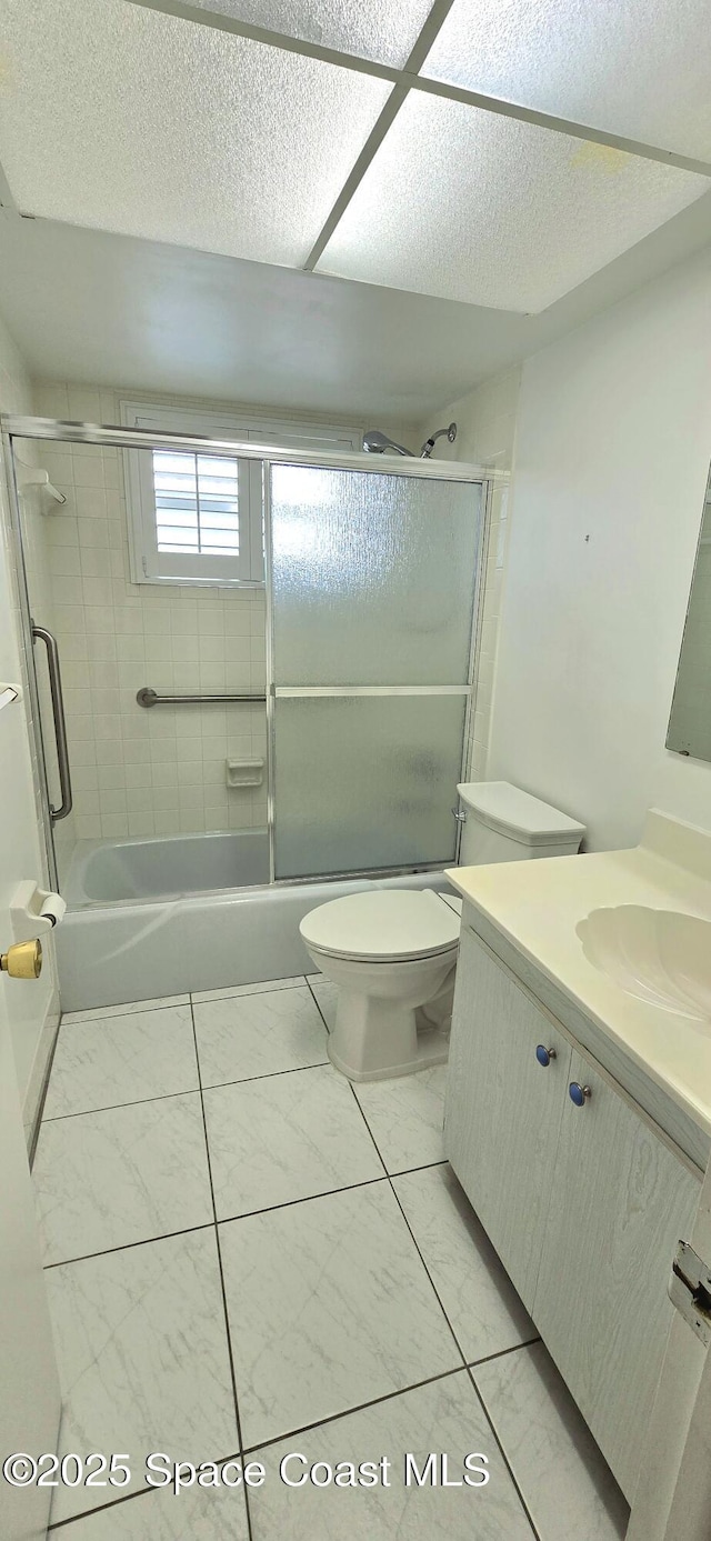 full bath featuring toilet, vanity, and enclosed tub / shower combo