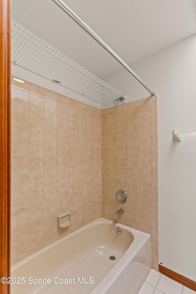 full bathroom featuring  shower combination, baseboards, and tile patterned flooring