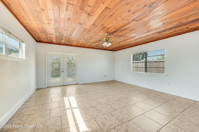 unfurnished room featuring light tile patterned floors, plenty of natural light, a ceiling fan, and french doors