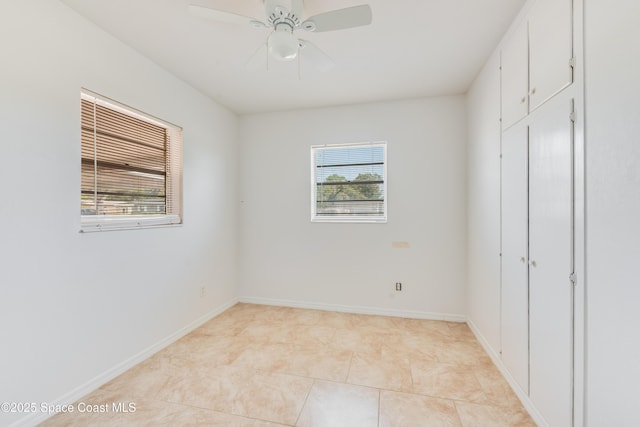 unfurnished bedroom with baseboards, ceiling fan, light tile patterned floors, and a closet