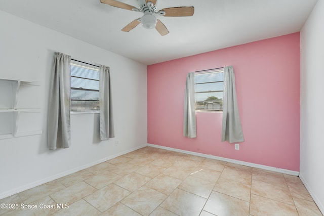 spare room with baseboards, a ceiling fan, light tile patterned floors, and a healthy amount of sunlight