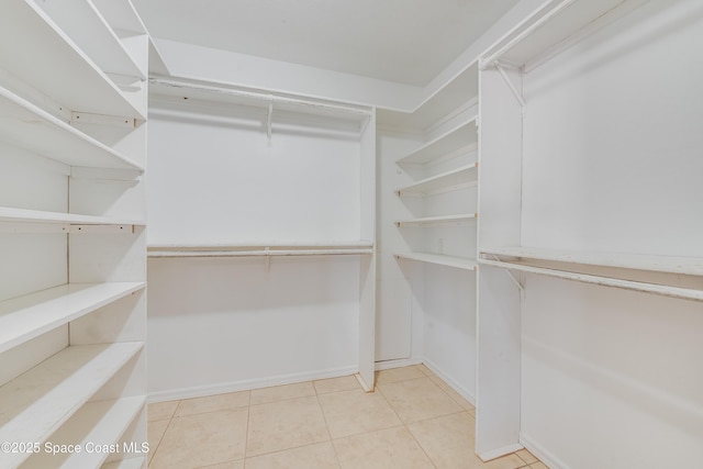 spacious closet with light tile patterned floors