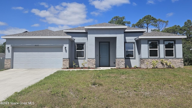 prairie-style house with a garage, a front yard, stone siding, stucco siding, and driveway
