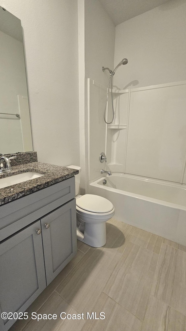 full bath featuring toilet,  shower combination, and vanity