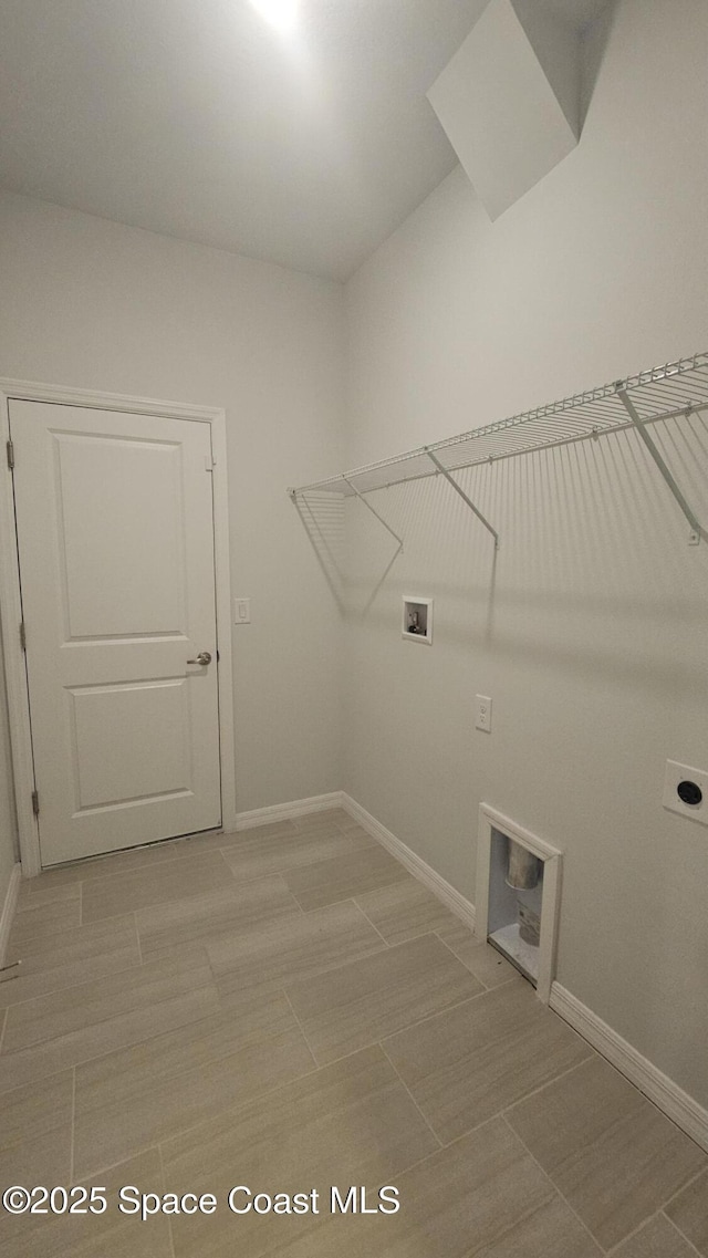 laundry area with baseboards, laundry area, hookup for an electric dryer, and washer hookup