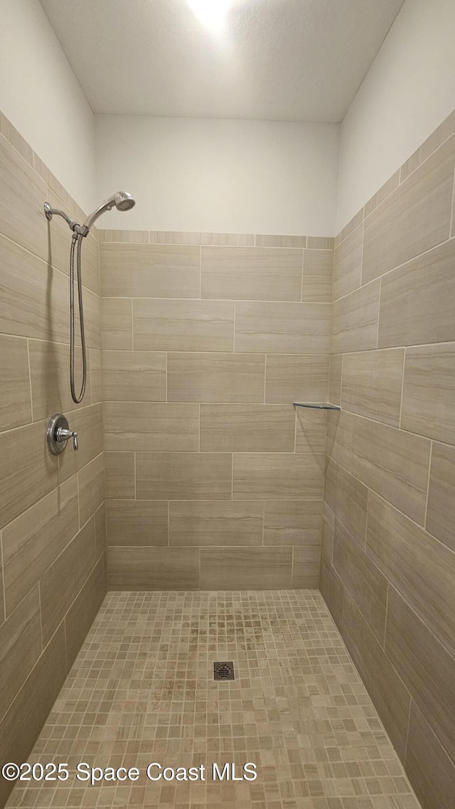 bathroom with a tile shower