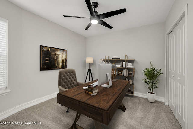 office featuring baseboards, ceiling fan, and carpet