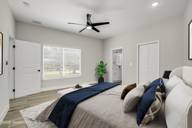 bedroom with visible vents, wood finished floors, baseboards, recessed lighting, and connected bathroom