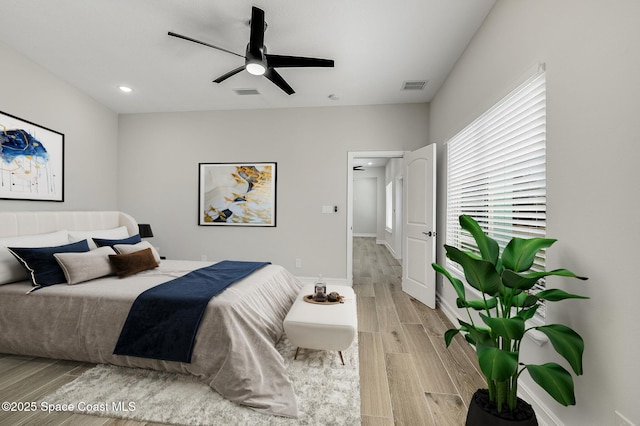 bedroom with visible vents, recessed lighting, light wood finished floors, and baseboards