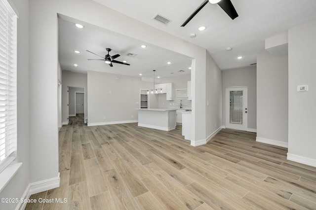 unfurnished living room featuring recessed lighting, ceiling fan, visible vents, and light wood-type flooring