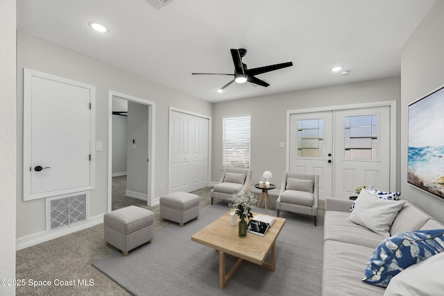 living room featuring carpet flooring, a ceiling fan, baseboards, recessed lighting, and visible vents