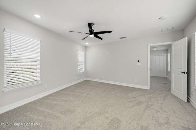 unfurnished bedroom featuring visible vents, recessed lighting, baseboards, and light colored carpet