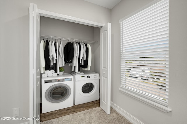washroom featuring laundry area, washer and clothes dryer, carpet, and baseboards