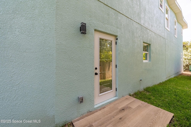 doorway to property with stucco siding