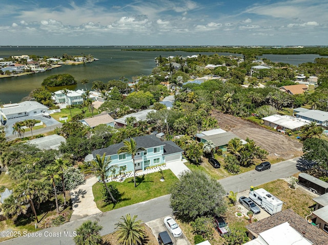 birds eye view of property with a water view and a residential view