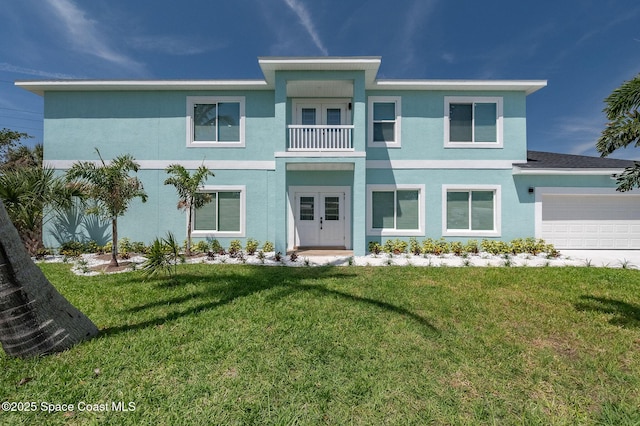 view of front of house featuring french doors, a balcony, a front lawn, an attached garage, and stucco siding