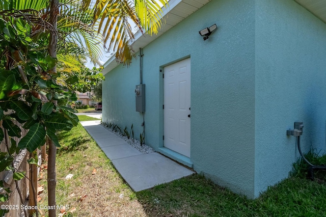 view of exterior entry with stucco siding