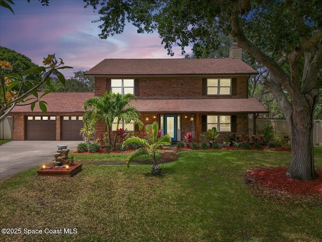 traditional home with a lawn, fence, a chimney, concrete driveway, and an attached garage