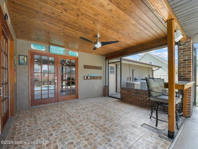 view of patio / terrace with french doors, a ceiling fan, and cooling unit
