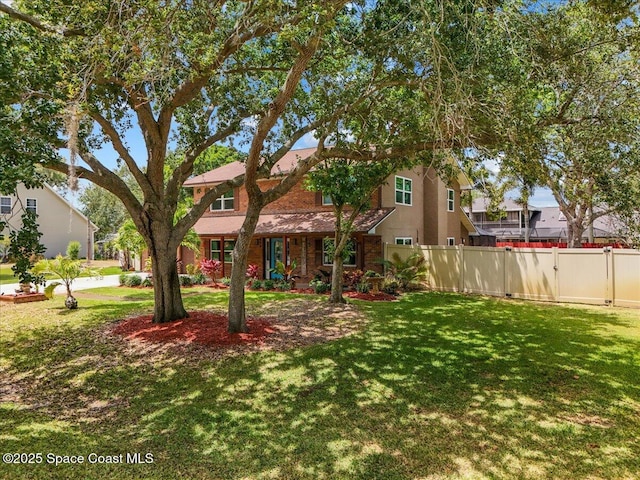 view of front of home featuring a gate, a front lawn, and fence