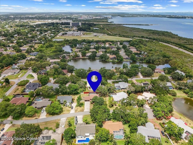 birds eye view of property with a water view and a residential view