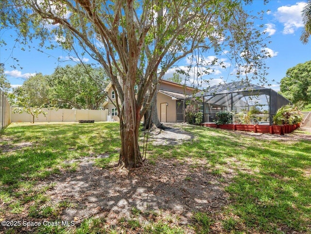 view of yard featuring a lanai and a fenced backyard