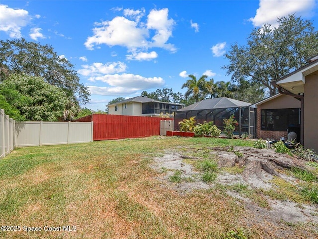 view of yard featuring a lanai and a fenced backyard