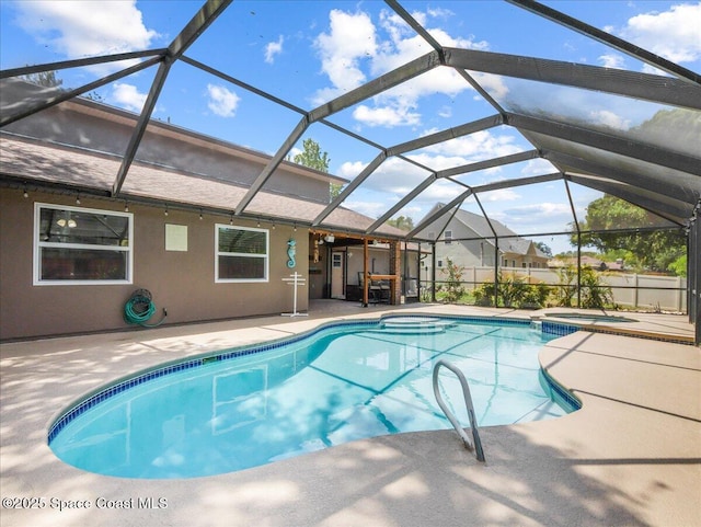 outdoor pool featuring a patio and an in ground hot tub
