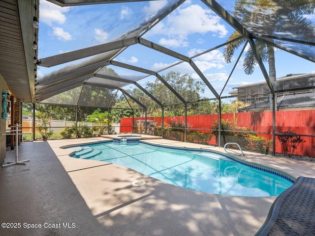 view of swimming pool with a pool with connected hot tub, a lanai, a fenced backyard, and a patio area