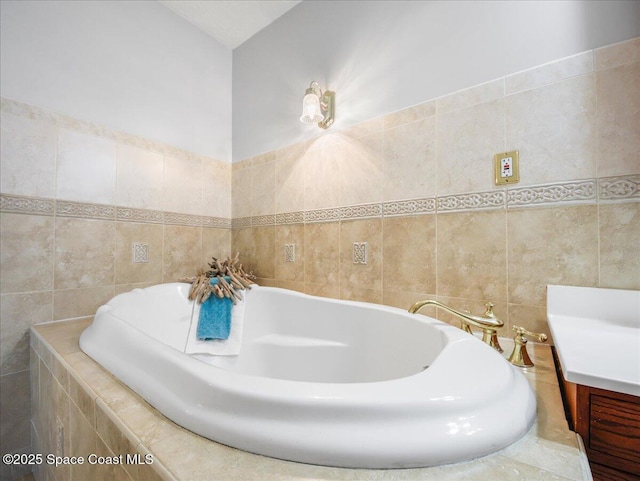 bathroom with tile walls and a garden tub