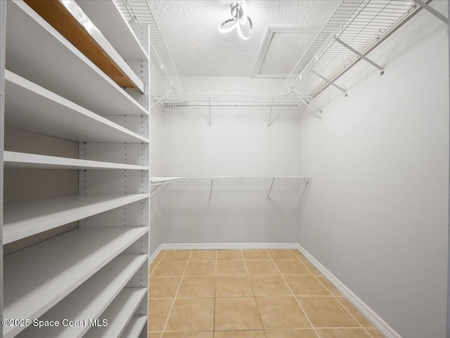 walk in closet with tile patterned flooring