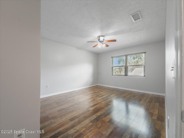 empty room featuring a ceiling fan, a textured ceiling, visible vents, baseboards, and wood-type flooring