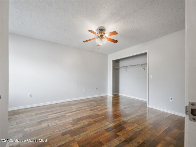 unfurnished bedroom featuring wood-type flooring, a textured ceiling, a ceiling fan, baseboards, and a closet