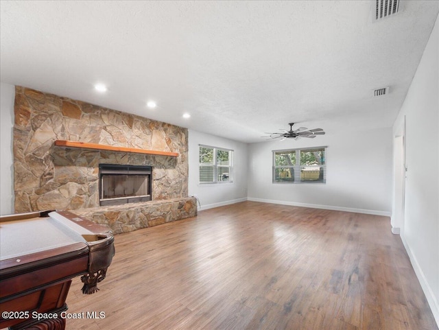 living area with visible vents, wood finished floors, baseboards, billiards, and a ceiling fan