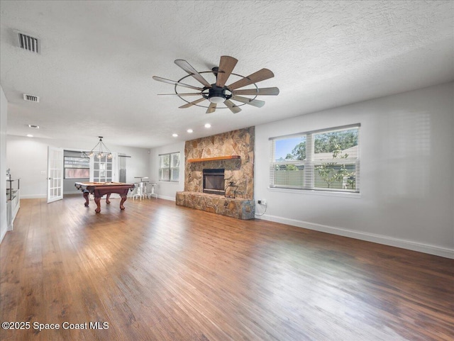 unfurnished living room featuring a healthy amount of sunlight, pool table, and visible vents