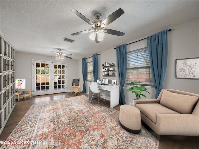 office space with french doors, a ceiling fan, a healthy amount of sunlight, and visible vents