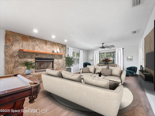living room featuring visible vents, recessed lighting, wood finished floors, and a fireplace