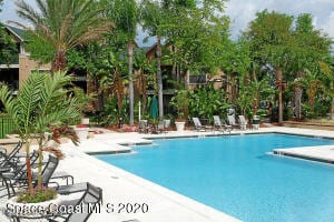 7667 N Wickham Rd Unit 903, Melbourne, FL 32940 - community pool featuring a patio