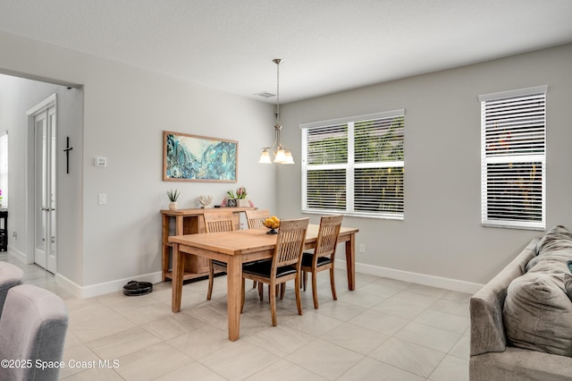 dining room featuring light tile patterned flooring, baseboards, and visible vents