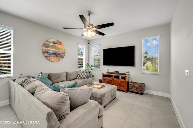 living room featuring plenty of natural light, baseboards, ceiling fan, and light tile patterned floors