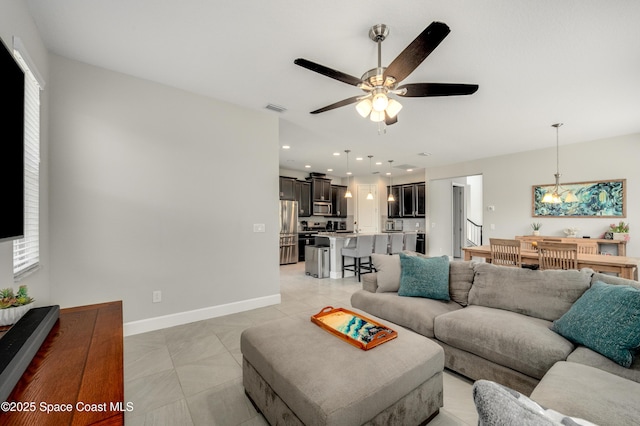 living room featuring baseboards, a ceiling fan, light tile patterned flooring, and visible vents
