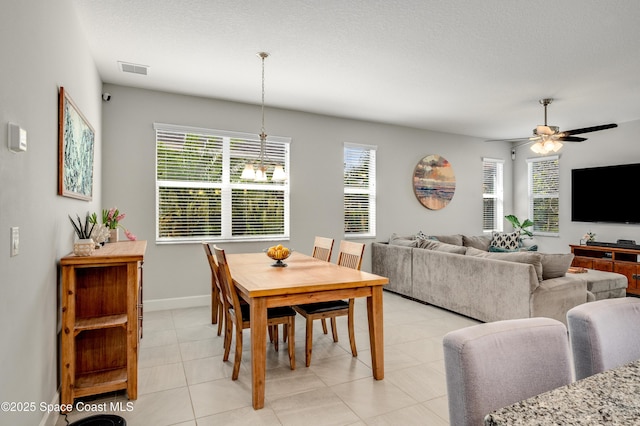 dining space with a ceiling fan, baseboards, visible vents, and light tile patterned floors
