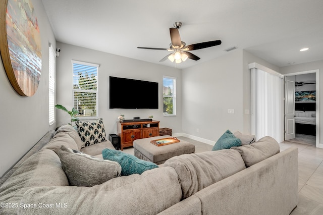 living room with plenty of natural light, ceiling fan, and visible vents