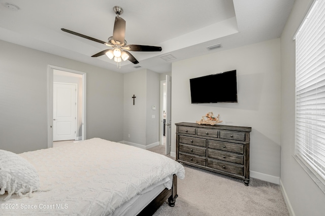 bedroom with visible vents, baseboards, ceiling fan, and light colored carpet
