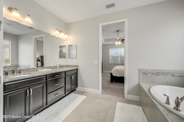 ensuite bathroom featuring visible vents, a sink, and connected bathroom