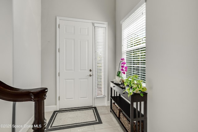 entrance foyer featuring baseboards and light tile patterned flooring