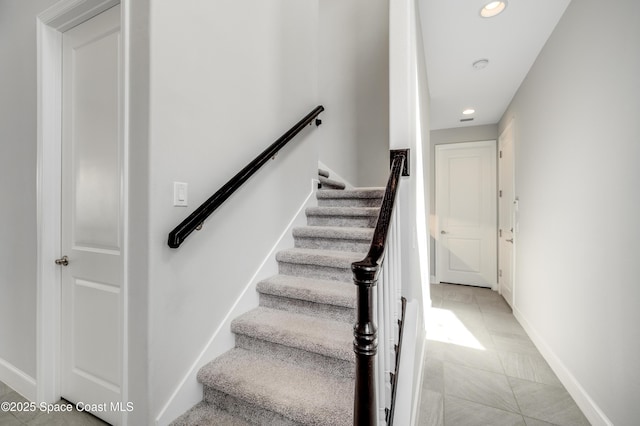 staircase with recessed lighting and baseboards